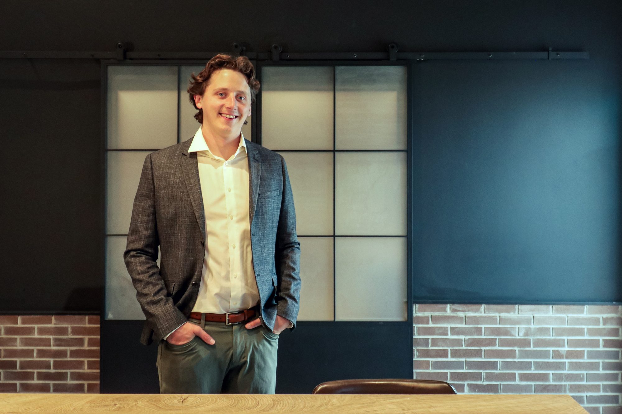 Steven Lipp standing in front of a steel-framed glass door